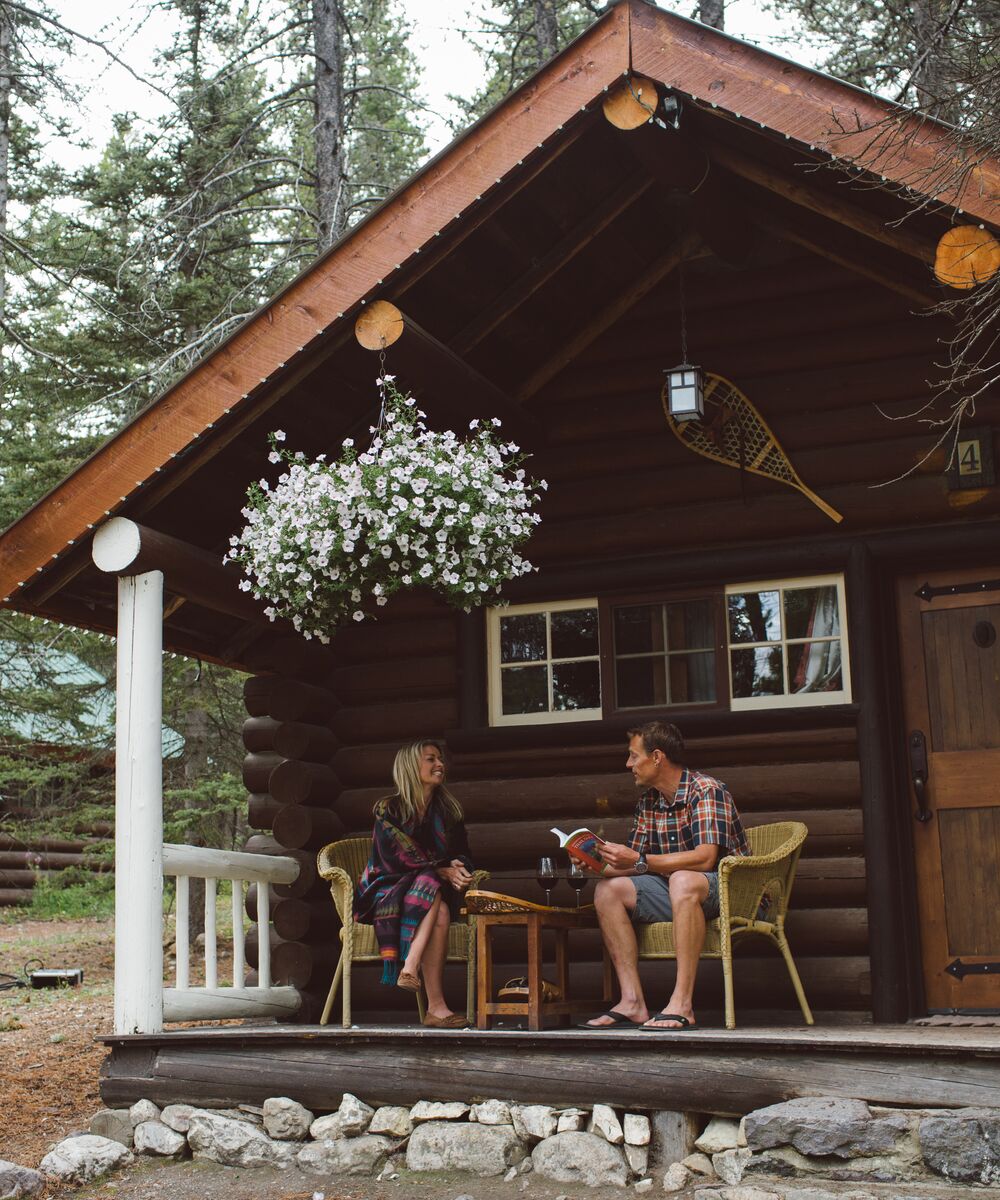 A couple enjoying a stay at a quaint mountain cabin in Banff National Park.